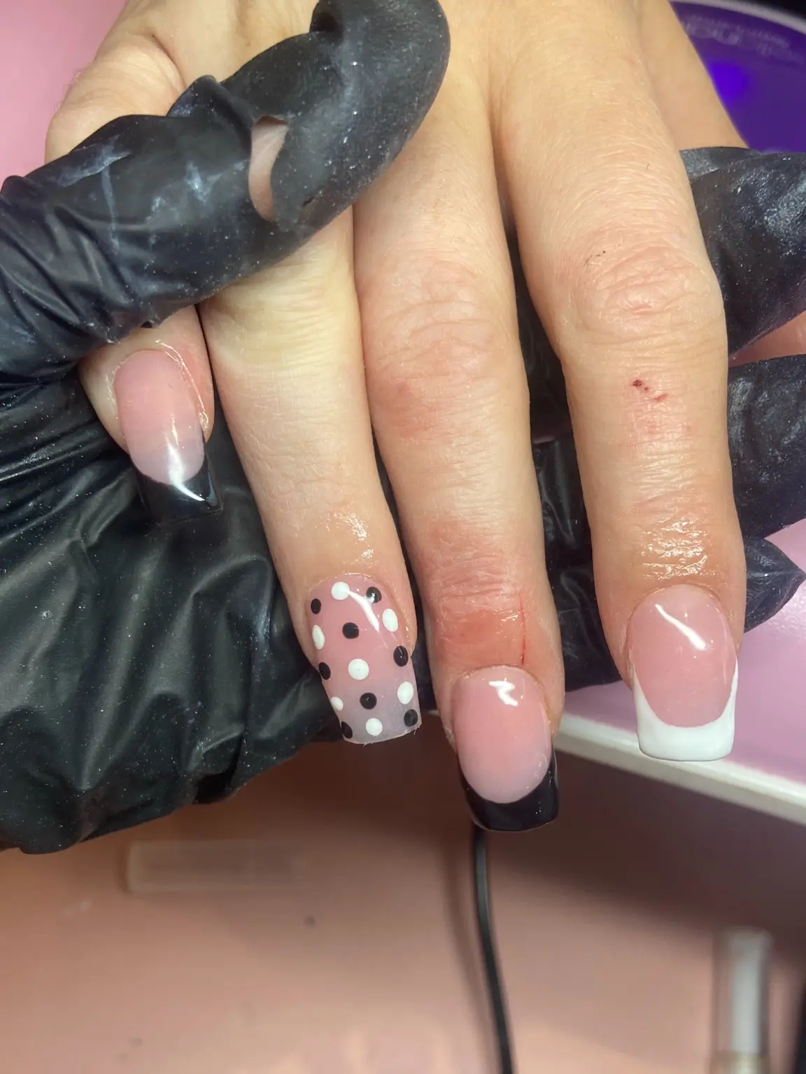 Pink French manicure with polka dot accent by Sets By Rhi